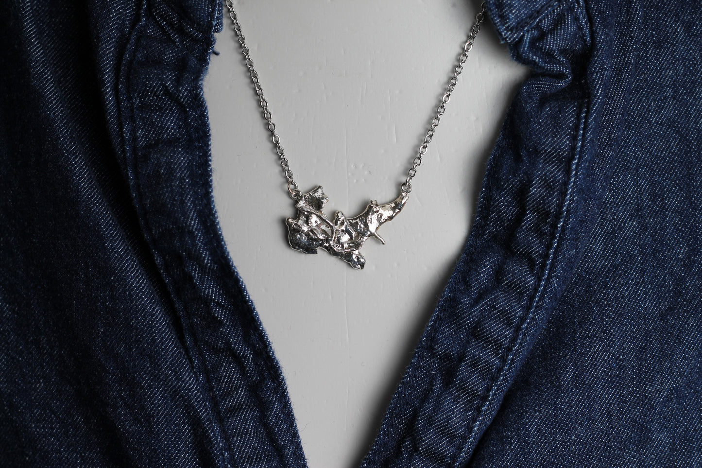 Unique handcrafted silver talisman with a volcanic molten finish  showcasing authentic Austrian jewelry craftsmanship.